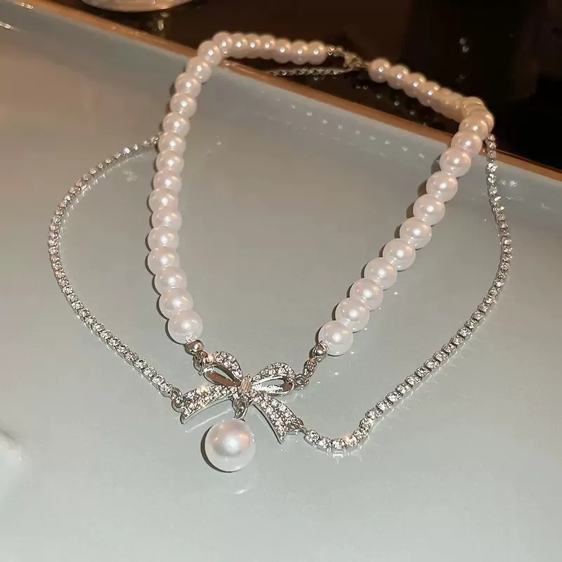 N-stl158-ສາຍຄໍ Pearl Bow Grace – ໄຂ່ມຸກໂບວ໌ປະກາຍ
